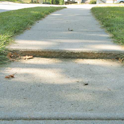 Sinking uneven concrete sidewalk