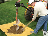 Auguring a hole in the earth for a foundation repair in Canton