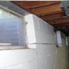 A foundation showing severe inward buckling along the windows in a Metairie home.