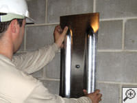 Mounting a foundation wall plate for an earth anchor installation in Brookhaven.