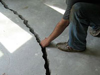 a severely damaged cracked concrete slab floor in Biloxi