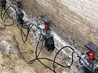 Using foundation push piers to lift a foundation during a repair in Ridgeland.