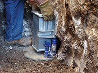 Securing a foundation footing bracket for a foundation repair system in Greenville.