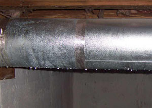 condensation collecting on an HVAC vent in a humid Canton basement